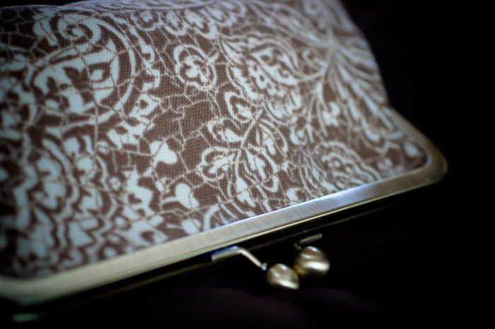 How beautiful is this fabric clutch paired with the antique brass frame?
